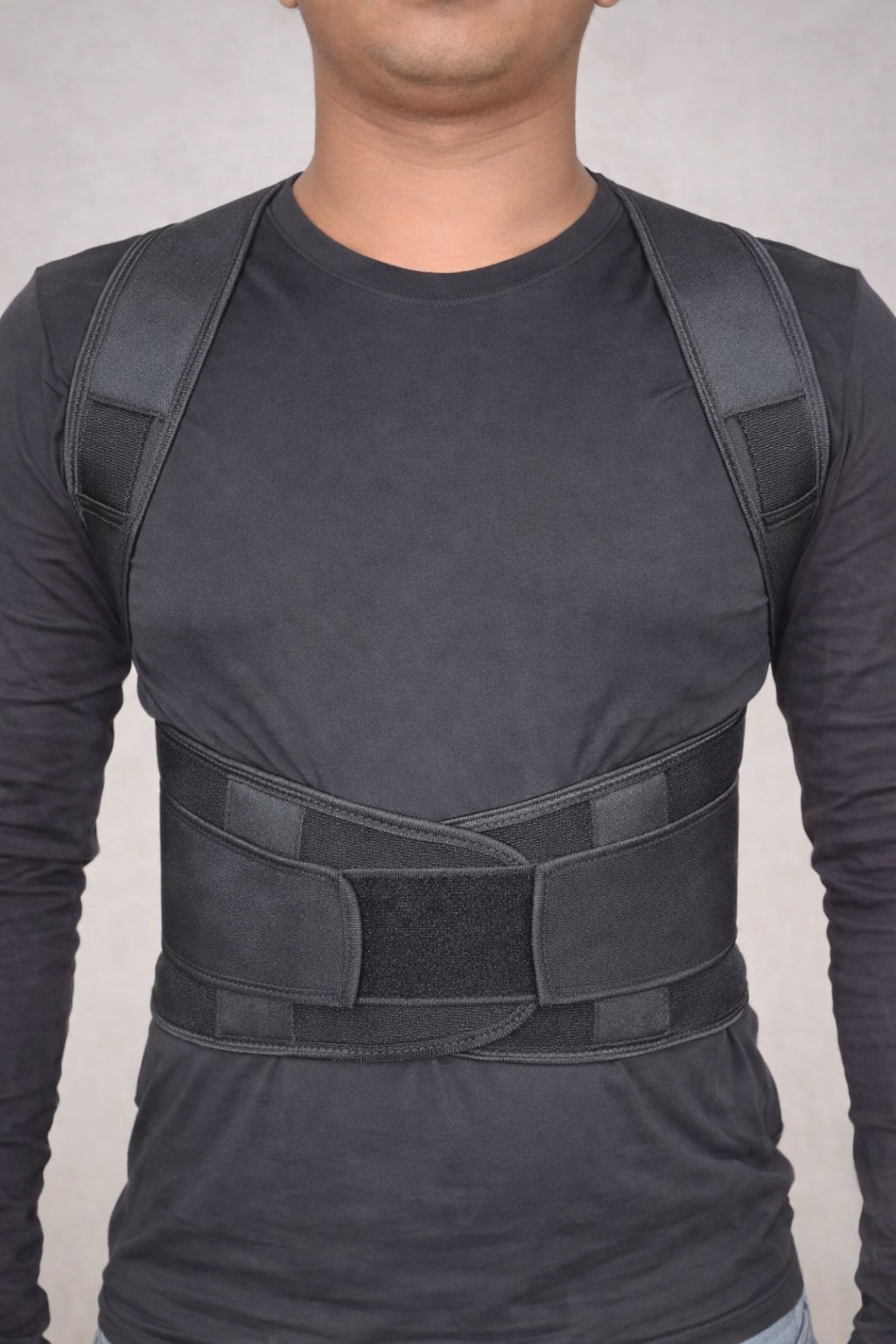 Upper back support brace — front view showing structured design with cross-back straps and lumbar panel for men and women